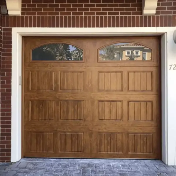Dark bronze garage door on a Mediterranean-style home