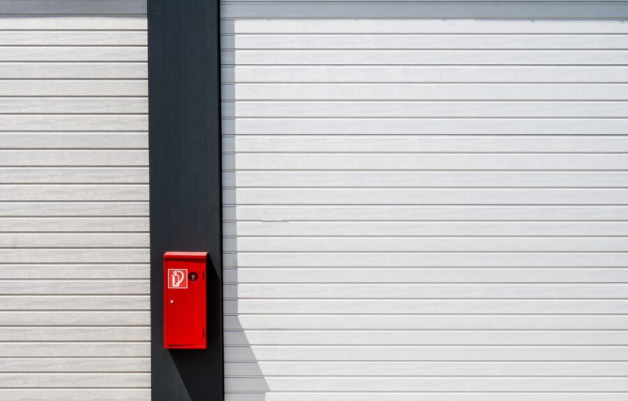 red-fire-box-hung-black-white-surface-with-lines_181624-5970